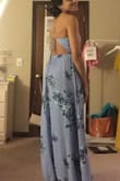 The open back has adjustable straps which is my favorite part of this dress. There is a lot of fabric so it feels a bit heavy for someone my size and will need to get it trimmed due to the long length. It's a pretty blue with beautiful flower prints! - Joselyne H.