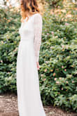To all those long-legged women out there! To make this dress work, I had to add a quarter of an inch to the length. I had a professional remove the original seems to let out the dress at the bottom. I also wore NO shoes my entire wedding day because 1) I hate shoes and 2) The handsome love of my life is 5'7" on a good day.
The dress lightly skimmed the ground so I was able to go ham on the dance floor the entire night without tripping. My toes peeked from under the solid white piece, but the sheer material on top was longer and hid them a tad. I only wore this dress for my bridal party photos, first look and reception. I wore my grandmothers gown down the aisle. So if a train down the aisle is important to you and you are tall like me this is not the dress for you. Great to party in though!
It did gape at my sides when I lifted my arms out to my sides but that's because of how the dress is designed. So if you are on the bustier side, I would be mindful of this (don't want to give eveyone a show). I had to wear a sticky strapless/backless bra. My now hubby loved the back, just the right amount for a girl who wants to show skin, but is usually on the more modest side.
The length of the sleeves was perfect for my long arms. Just passed my bony wrists and layed elegently on my hand.
Everyone was amazed and could not believe how inexpensive my dress was (a major reason I purchased it since I was a bride on a budget)! It also photographs beautifully. Super white and stunning. - Jessie D.