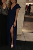Pretty deep V but can always use fashion tape to close it a little bit. Wore this to a wedding and a black tie event, material is comfortable and the slit is right where it should be. Love love love this dress. - Jamella A.