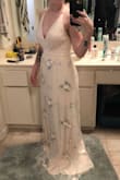 I got this dress in my round two of dress buying for my wedding (got It with 2 months to spare before the date). It is perfect for my small intimate, outdoor ceremony. Not too much, but not too casual. I obviously had to have it hemmed, but according to my friend, it was very easy to hem. The moment I tried it on, I fell in love with it and finally felt like a bride. I absolutely recommend this dress for any size. It is very flattering, easily altered, and a beautiful color. The waist isn't stretchy; so if you're not sure, go a size up. The straps are adjustable and there are actually two under-layers to the dress which makes it very not-see-through. Can't wait to wear it at my wedding! (Photo is pre-hemming, I'll add another later) - Angela F.
