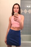 I love the color of the skirt, but was hoping it would be more fitted like how it looks on the model. There is just a little excess room around the legs (and waist), so I have to wear it slightly lower for the best fit on my body. If you want a tighter fit, I'd suggest ordering a size smaller. The material is somewhat stretchy too. I still think the skirt is cute and am planning on wearing it with a white crop tank and white sneakers or tan platform heels. - Elizabeth S.