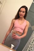 This top is super cute! I love the soft fabric and how the straps cross plus tie in the back. The pink is a fun spring and summer color... I'm planning on pairing it with high waisted light wash denim jean shorts and white sneakers or tan platform heals. You can wear it without a bra/sticky cups if you don't mind showing some nip bumps. I would like the fabric to be slightly thicker to reduce the nip factor, but it's not a huge deal. - Elizabeth S.