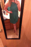 I bought this dress for my nursing school graduation. It is a beautiful emerald color in person and fits absolutely perfect. It will look nice with black or nude heels. It has just enough give around the stomach/hips that it doesn't cling to my tummy but is fitted enough that I don't look shapeless! Absolutely love it. - Maddysen H.