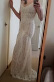 This dress is gorgeous! I purchased it to try for my reception wedding dress. Something just didn't quite click with it and it was hard to put my finger on. The attached pics are of me in a small, which fit much better than the medium. The lace is beautiful and well done, the dress is great quality! - Rachel R.