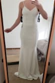 This dress is breathtaking. The medium was too big in my chest but fit perfect on my hips. The small is just a touch tight on my hips but fits my chest perfectly. It's perfect. The stretch of the dress itself is very flattering and comfortable. I will be wearing this for my wedding reception after I change out of my ceremony dress. The lace in the back of the dress is subtle and beautiful. So excited about this dress! I am sure it will blow my fiance away. - Rachel R.
