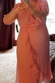 This dress fits true to size, which means the measurements given were accurate. However, it you are short waisted, as I am, you may find that there is too much material in the back of the dress, from neck to waist. The extra material bunches and doesn't sit flat. Since there is a back zipper, I didn't feel confident that it could be easily altered. It fit perfectly every where else, though. It's really a lovely dress. I'm disappointed to return it. - Ginger G.