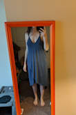 It's a comfy material dress. It's very low-cut in the front. The website says you can wear a adhesive bra with this dress, but that's absolutely wrong. There's no way. It's so low-cut, you would not be able to wear any kind of bra with this. I even adjusted the straps a ton just to get it to come up, but it's still very low-cut. I bought it for an upcoming vacation. - MARY B.