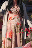 This is a gorgeous dress, great quality fabric, looks just like it does in the picture on the model. Because of my body type and height, I can't say I looked as great as the model does despite being very happy with the dress.
Ideally, this is a dress for a tall girl, me being 5'4" meant it dragged on the ground even with tall platform heels on. It wasn't too bad though, I just carried it in one hand sometimes like a princess would hold her flowing dress to make sure I didn't trip. Also, because there is so much fabric, it does add to the overall weight of the dress (though it still flows when you walk!) but yes, you feel the dress while you wear it, it is not weightless. The bust hangs loose and low so wear a good bra (and maybe some double sided tape!)
Because the dress arrived the day before the party, I had no time to alter it to be perfect. Otherwise I would have put it up to be better suited for my height and I actually had to safety pin the top together so it did not show as much cleavage. Lots on display up there. Overall, yes, get this dress. I still got compliments all night and you do kind of steal the show in it, it's that gorgeous and unique. It was cold so I had to wear a jacket/cardigan but the beauty of the dress still popped. - Alexia J.