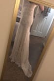 I bought this dress for my wedding and LOVE IT! It fits so well, and is light and comfortable. It has a very small train on the back that I think is beautiful. It is a pretty off-white shade which is just what I was looking for! So excited to wear it in June! - Kristen A.