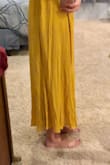 I was not crazy about this dress at all for the price I paid. The material is very thin (I don't know how you could wear a bra with it and have it not show) and wrinkles very easily. My biggest concern though was the length.... I don't know how anyone over 5'8 could wear this. It was at least 2 inches too short. While the dress flowed nicely and was fun to walk around in, I would have only paid $30 tops for a dress of this quality. I'll be returning. - Laura M.