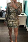 This dress is absolutely stunning and it has a LOT of stretch! I wish I would've sized down!! I have loose fabric hanging everywhere. :( - Karri D.