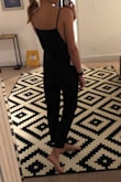 The material is a little stiff, but I think it will wear in well. The straps are adjustable based on where you choose to tie them. Really cute with a tank or tee underneath. - Kourtney L.