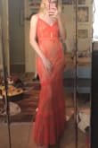 The material on the inside is extremely comfortable and silky and overall it is extremely flattering. The orange/coral color is almost neon in person which was a little unexpected, but it's still such a beautiful dress!! waist=snatched. - Amelia W.