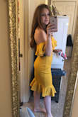 Just a classic style for the derby and a really fun color!! It is more mustardy/golden yellow than a true yellow. I still love it though. The waist didn't bunch on me like some reviews said, but I did feel it is a bit loose. I probably could have also gone for a XS because I have a smaller chest, but I will enjoy the extra space, having to walk around all day. Overall, great quality. Feels sturdy and supportive. - Brittany T.