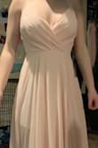 This dress is pretty flattering and fits true to size. I will be getting this dress hemmed as it is too long for me but other then that it's a beautiful dress. - Averi B.