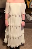 It's really comfy. I was worried about the shoulders falling of that the elastic would pull it up, but it seems to stay put. I bought it for my wedding reception because I am trashing my ceremony dress. So I don't have great photos of it, but hopefully this helps. - Amanda B.