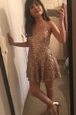 I bought this dress in an XS based on other people's reviews and it fit perfectly! The dress was beautiful, I wore it to a college ball and got lots of compliments. :) - Yasmeen B.