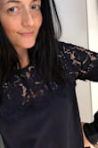 When I opened this shirt out of the box I thought for sure it would be larger than expected. I was wrong, this fits perfectly. I love that it's a bit loose but not large. It looks super cute and classy. Highly recommend. - Paula D.