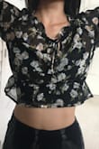 I so wanted to love this. The material feels light and the sheerness looks really elegant with a bralette underneath. The torso is really short, which would be fine, but there isn't enough give in the underarm and shoulder area so when I lift up my arms, the shirt rides up all the way to my underboobs, and when I bring my arms down, the elastic band at the bottom of the shirt makes it stay up there. Really wanted to love this top, but I get anxiety just thinking about how often I'd need to readjust or worry about keeping my arms down. - Kristine L.