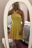 Vibrant beautiful yellow. Fits perfectly. Falls before the knee after my fingertips. Got it for my college graduation - Miranda B.