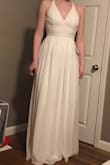 I really, really like this dress. If it was an inch or two longer, I would keep it, but as is, I couldn't wear shoes with this dress :( I think others have noted that the lace panel in the back looks like it might be silvery/shiny based on the photos, but no, it is just plain ol' white lace. It's very comfortable lace, stretchy and not scratchy at all. Also, I'm a smaller-chested lady, and the bust definitely had a bit of odd gaping, even when I threw a bra on to try to fill the top a bit more. So maybe better for ladies with a bigger bust. - Elissa S.