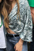 This top is sooooo cute and flowy. It can be retied on the front and sleeves. - Sarah H.