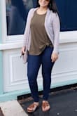 I liked this top a lot - however it was a bit big. I actually tied it like the model did for a bit tighter fit which made it look cuter. The arm holes were still too big so my bra showed a bit- but I just wore it with a light cover-up. - Jennifer