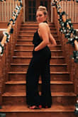 I absolutely love this jumpsuit. I've worn it for multiple occasions, very versatile. Fits true to size, very comfortable, covers everything that needs to be covered. I don't wear a bra with it and it looks just fine. Love this! One of my favorite items in my closet. - Payton S.