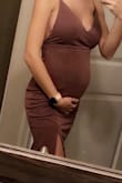 I am almost 20 weeks pregnant and this dress is super soft and stretchy. Did not fit tight which is fine with me. Just note not one of those materials that hold you in tight. Very well made. Super cute. - Inese F.