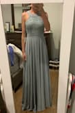 I purchased this dress as a bridesmaid dress. It fits beautifully and is perfect for someone busty like me. It comes in at the waist for a very figure flattering cut. I returned it because the bride was looking for something more green when she said "sage." This dress is more blue than green. - Hillary L.