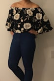 I didn't expect this top to be more of a crop top, but it is. The bottom hits around the belly button area. I wore this top with high waisted jeans to keep my belly from being exposed. Also this top definitely slides up to your shoulders, which could get really annoying. You definitely need to keep your arms pretty low to keep it from riding up. - Ariane