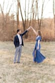 This dress is a beautiful color and fun to wear. It was the perfect height with short heels on and did not need hemmed for my height. Wore it for my engagement pictures and love how they turned out. It is a true wrap dress but had a button at the V neck to keep it closed. It is a thinner material so I would wear it more for warm weather. - Emily S.