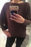 It's flattering because it's very fitted in the lower arms and then at the bottom. It's not as long on me as in the photo but I have a long torso. I can wear it with black pants for work or with jeans on the weekend! It's a good staple to have! - Victoria A.