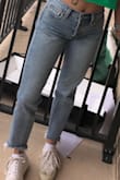 These are the best jeans!! The fit of them is perfect for the style I was looking for. They fit me true to size for the most part, tighter on the top of the pant and looser towards the bottom of the pant. I love the high waist on these jeans- it fits my waist at the perfect height. I usually pair them with a belt and it looks so good! The length fits just above my ankle, about the same length as shown on the model, which is perfect for me because I don't have to roll them up which I find that I have to do with most jeans. These jeans fit me somewhat loosely on the ankle, and I expected a tighter fit when looking at the picture, but they still look good paired with most shoes. They are definitely more loosely fitted on the lower area of the pant than shown on the model. - Kileigh P.