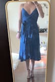 The color is a little different in the picture, but I actually love the deep royal blue color. I usually wear a medium in size, but I fit into a small perfectly in this dress. Despite other reviews, it covers my chest area perfect and does not feel too revealing at all. Definitely recommend! I will be wearing this to a wedding this summer. - Nicole S.