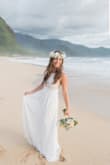 I wore this dress on our wedding day in Hawaii. It was truly a dream. The dress is true to size, but I am large in the chest area so I did have to get about 4 inches taken off the bottom and some alterations on the top half. The dress has 3 layers and a slip. Not too heavy, but great quality. I love love love this dress!! - Irene R.