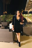This is such a glamorous and sexy dress. The velvet gives it a really sophisticated touch and full flare sleeves add coverage as the neck is quite deep. There will be cleavage so don't go for it unless you are comfortable with that or plan to wear a slip inside. I wore it for my bachelorette party and received tons of compliments :) - Anushka B.