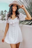 This dress is the perfect white dress for summer! The puff sleeves and tie in the front make it super cute. It's not see through at all which I love. - Sabine T.