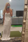 I am so in love with this dress. I am wearing it to my beach wedding. It fit greats though it is a little long. Expect to get it hemmed if you are on the shorter size. Pictures do not do the dress justice for how beautiful it is! - Erin O.