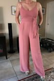I have a really hard time finding jumpsuits that are flattering, since I have a freakishly short torso (even for my height) and a relatively larger chest and butt.  Most end up looking really dumpy and baggy with the crotch sitting closer to my knees than where it should, and the top having too much material and nowhere to go.  This one really worked though!  I think it would work for someone with normal proportions too, because the material has some give and there was still space in the crotch, but didn't look diaper-y.  Pant legs are super long - I have a 32" inseam and added 5" wedges in the photo.  For reference, I typically wear a 27 in jeans and 6-8 in dresses depending on the cut, and the M fit perfectly.  Bonus: pockets! - Francesca M.
