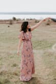 Absolutely love this dress! The flutter sleeves are very flattering at slimming the shoulders and the faux wrap tie completes the dress. I had it hemmed for my height which may cost a bit more than expected because there is a nice liner underneath. It is very comfortable. Wore it for my engagement photos. - Adrienne N.