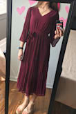 I am excited to wear this dress! I ordered it to wear to church and to some weddings I have this summer, and it's perfect. The color is stunning, the v isn't too low, the pleats are fun, and the bow is cute and slimming for the waist. The back is sheer, so my bra may be seen a little, but I don't mind that. It is a little long too, but with heels it'll look great. - Liz R.