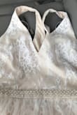 This dress fit gorgeous and was true to size. The lace is very beautiful as well. The only problem with the dress is that the color is not what is advertised. On the website it is clearly white on white, but what I received was tan underneath with some white lace overtop. The dress was lovely, but I was disappointed with the color . - Riley H.