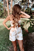 I really do love this top because it matches the shorts but it will not stay up. I tried tying it tighter but it somehow still wants to slide down. I might try tape to see if that helps. - Laci P.
