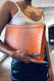 This is a sizable clutch with a secure closure and awesome design. The color is just as pictured. - Jasmine C.