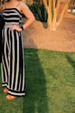 I bought this jumpsuit for a sorority formal, and it was a hit!! It was so comfortable, fit perfectly, and looked amazing on. Not too much stomach showed which was so nice because I was a little nervous. On me, even less showed than on the model. This does run long, so I had to wear my highest heels, but I loved this outfit! - Anne C.
