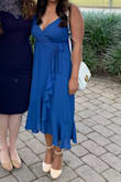 I wore this to a friend's wedding and received many compliments. As other reviews noted, the actual dress is more royal blue which is disappointing but still pretty. I ordered a size up based on other reviews. I think the dress fit well but the bust area was loose, and I have a larger bust. I used safety pins to pull the two sides closer together so that I was more covered up. Worked well after several attempts of pinning just right. Would recommend this dress! - Michael R.