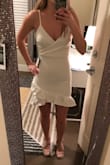 I got this for graduation and it's really cute and true to size! It's stretchy which is nice. Need to have it dry cleaned to settle the ruffles. - Breanna G.
