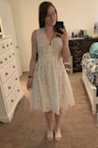 Super cute dress. Good quality lace material. I'm normally always a small but the waist was about an inch too big. I don't think I'll risk it to get an XS instead. So I'll keep the small! I might add a ribbon or belt or something to waist line to make it look a little more snug. It's the perfect length. It has a nude slip underneath, a layer of tulle, and then the lace over top. I might remove the tulle cause it makes the dress look a little too poofy. Makes me look a size too big. :/ Either way, good quality dress. - Lisa A.