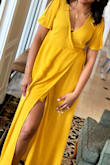 The dress is light and fun. Beautiful color. Ordered an XS so the dress does run big because I'm usually a small medium. Wore it to a bridal shower. Would totally recommend. - BreAnna S.